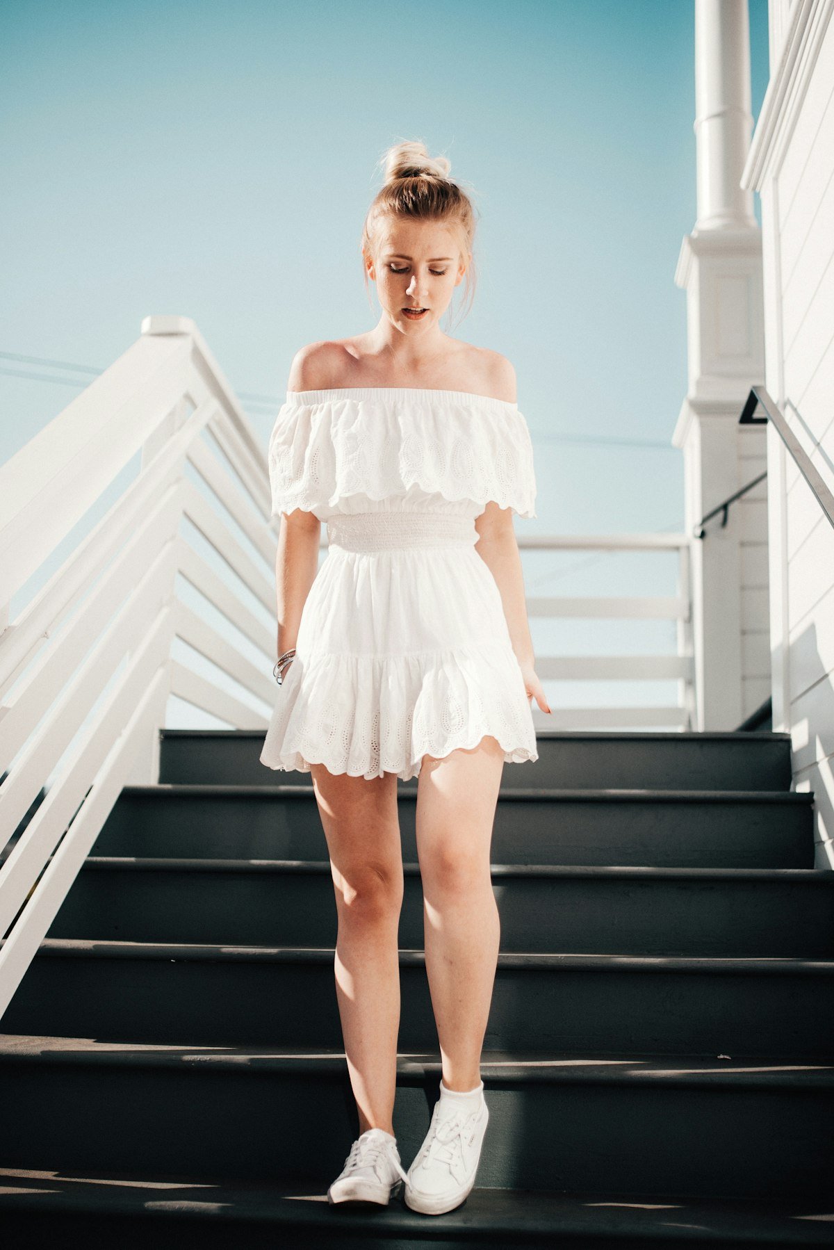 Woman in an elegant white off-shoulder dress