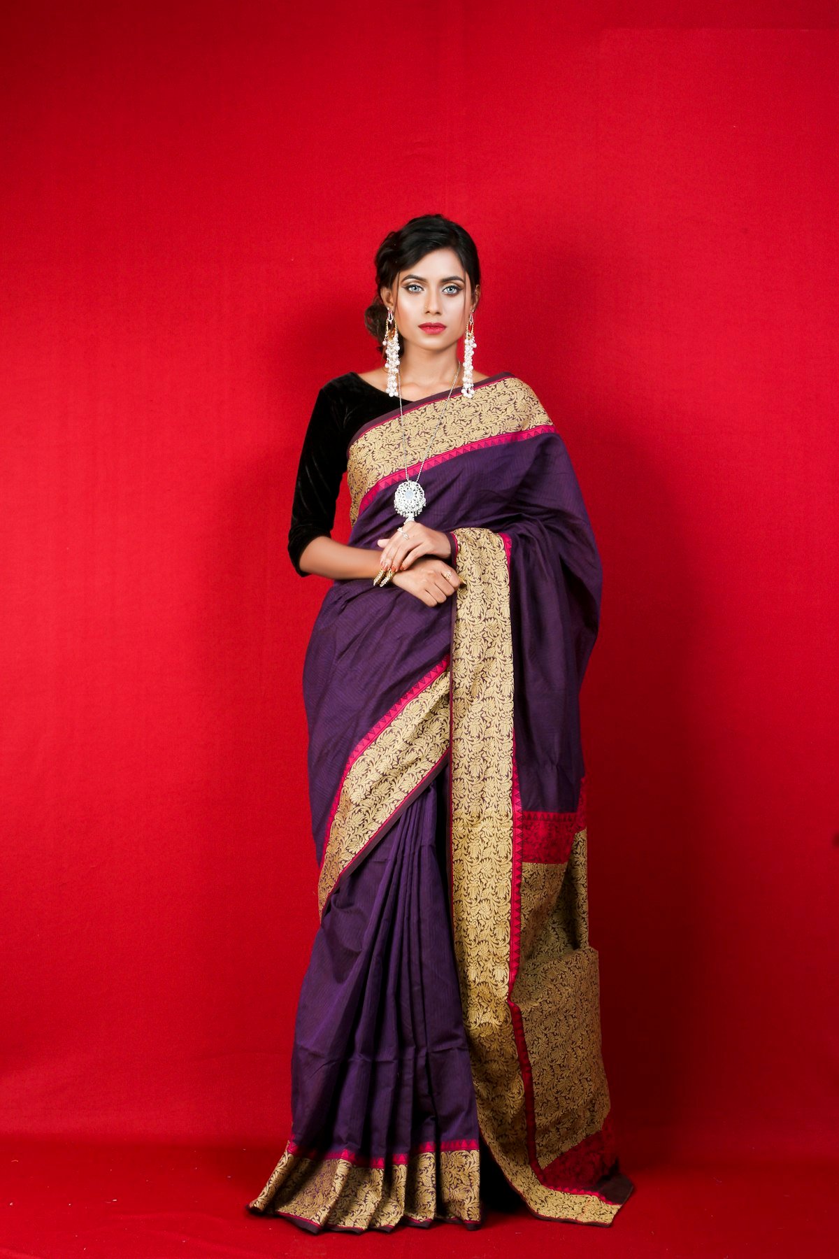 Woman in a traditional purple and gold saree — ethnic and occasion wear