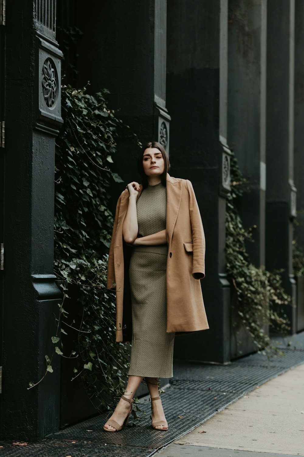 Woman in a timeless camel coat outfit on a city street